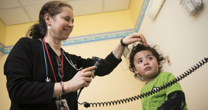 Provider using otoscope on patient