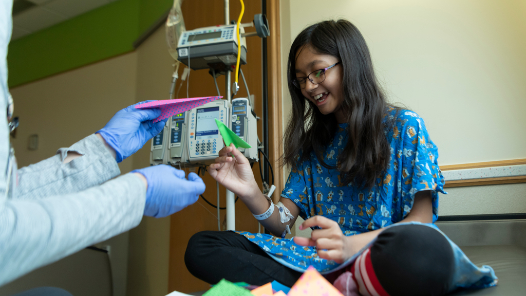 young patient plays with paper airplanes